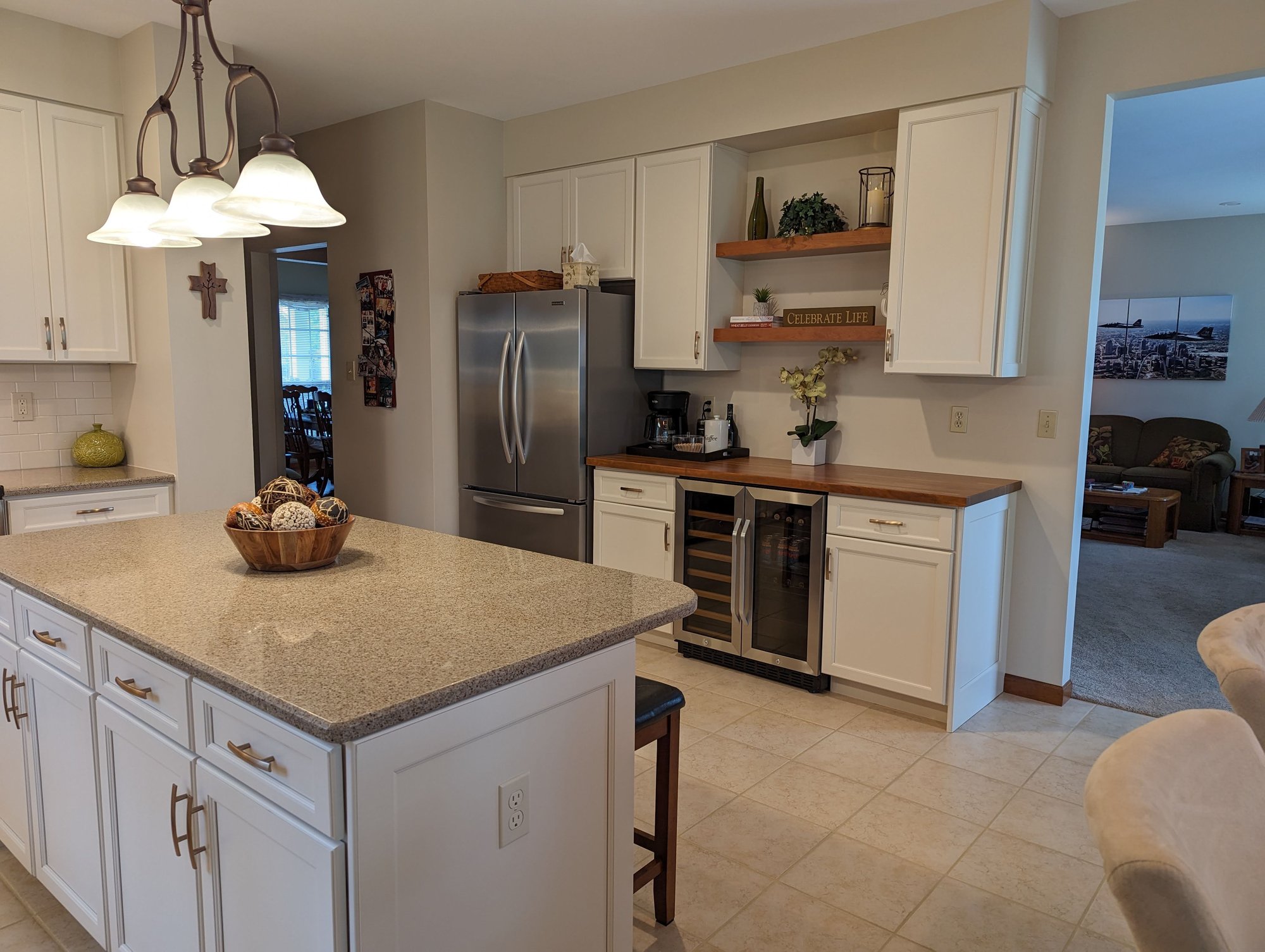 After Picture: Desk height cabinets replaced with standard height with space for beverage cooler. Wall cabinets replace and floating shelves added between